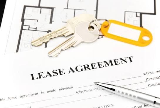 A seller leaseback agreement being signed at a closing table