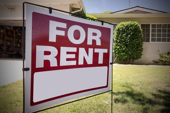 A realtor reviewing a lease agreement with a tenant